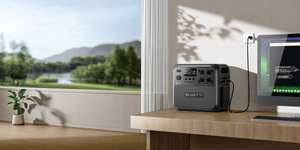 Bluetti Elite 200 V2 charging beside a computer