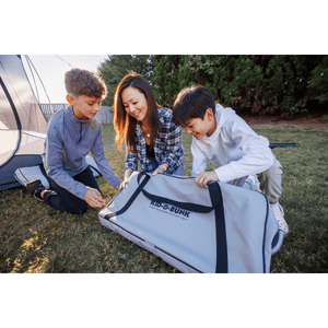 Kid-O-Bed single kids camping bunk bed being set up by woman and kids
