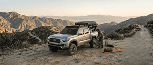 Overland Vehicle Systems Expedition Truck Cap for 2016 to 2023 Toyota Tacoma set up on mountain trail