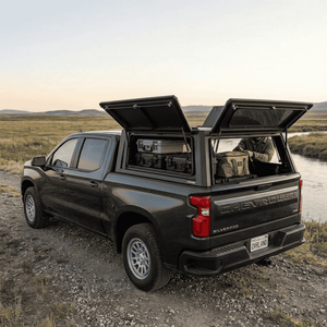 Overland Vehicle Systems Expedition Truck Cap for 2019 to 2026 GM Silverado/Sierra 1500 - 5.8 ft. Bed parked with panels opened