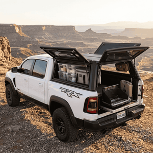 Overland Vehicle Systems Expedition Truck Cap for 2019 to 2026 Ram 1500 DT - 5.7 ft. Bed parked with panels opened