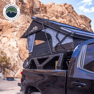 Overland Vehicle Systems Universal Mid Height Rack for Pick Up Trucks with rooftop tent installed