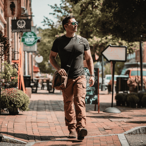 White Duck Outdoors Filios Messenger Bag with man walking down the street