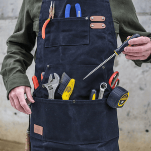 White Duck Outdoors Black Work Apron with tool-filled pockets