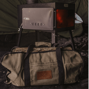 White Duck Outdoors Woodsman XL Wood Stove Kit opened and burning with close up of log carrier bag