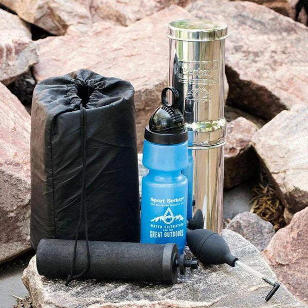 Berkey travel filters and water bottle on rocks
