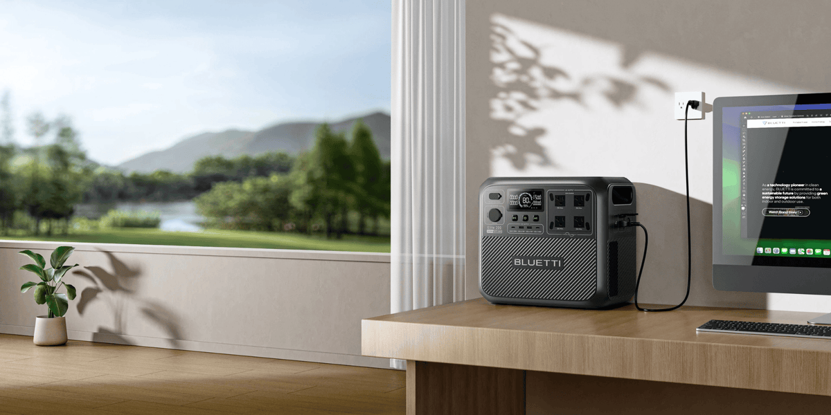 Bluetti Elite 200 V2 charging beside a computer