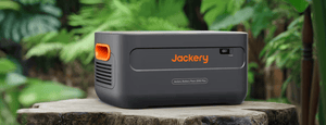 Jackery Battery Pack 2000 Plus on tree stump in jungle
