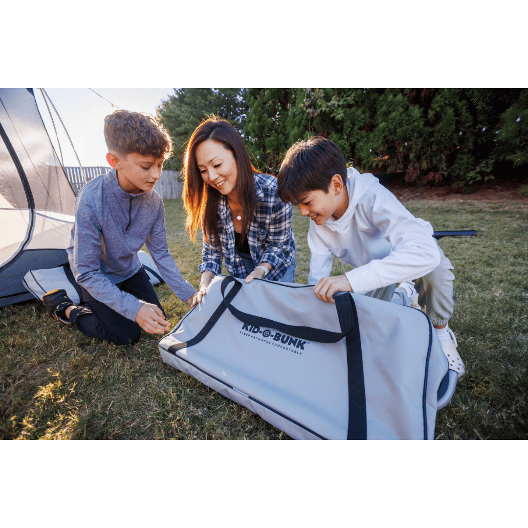 Kid-O-Bed single kids camping bunk bed being set up by woman and kids