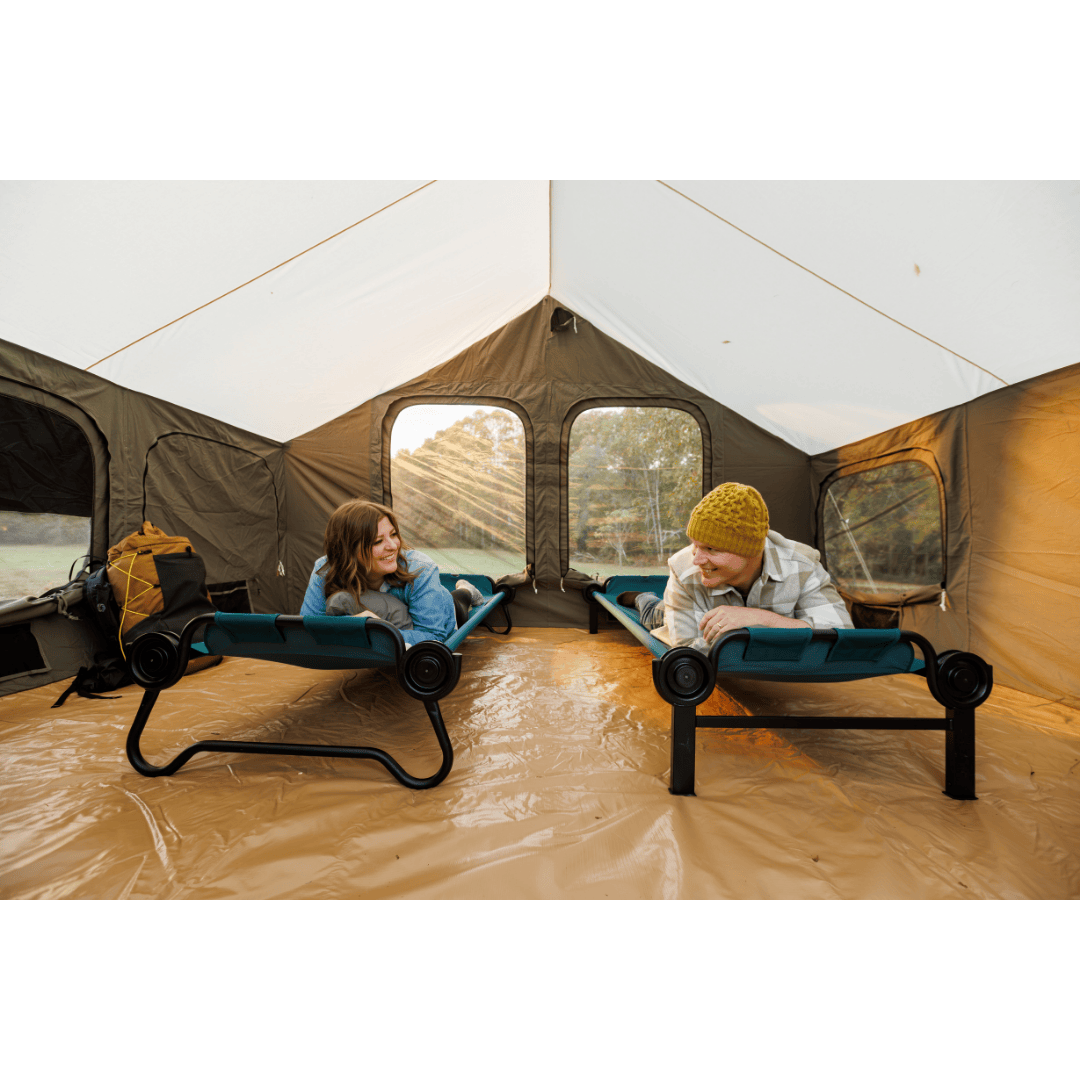 Large Disc-O-Bed Portable Cot System unstacked with two people laying face down