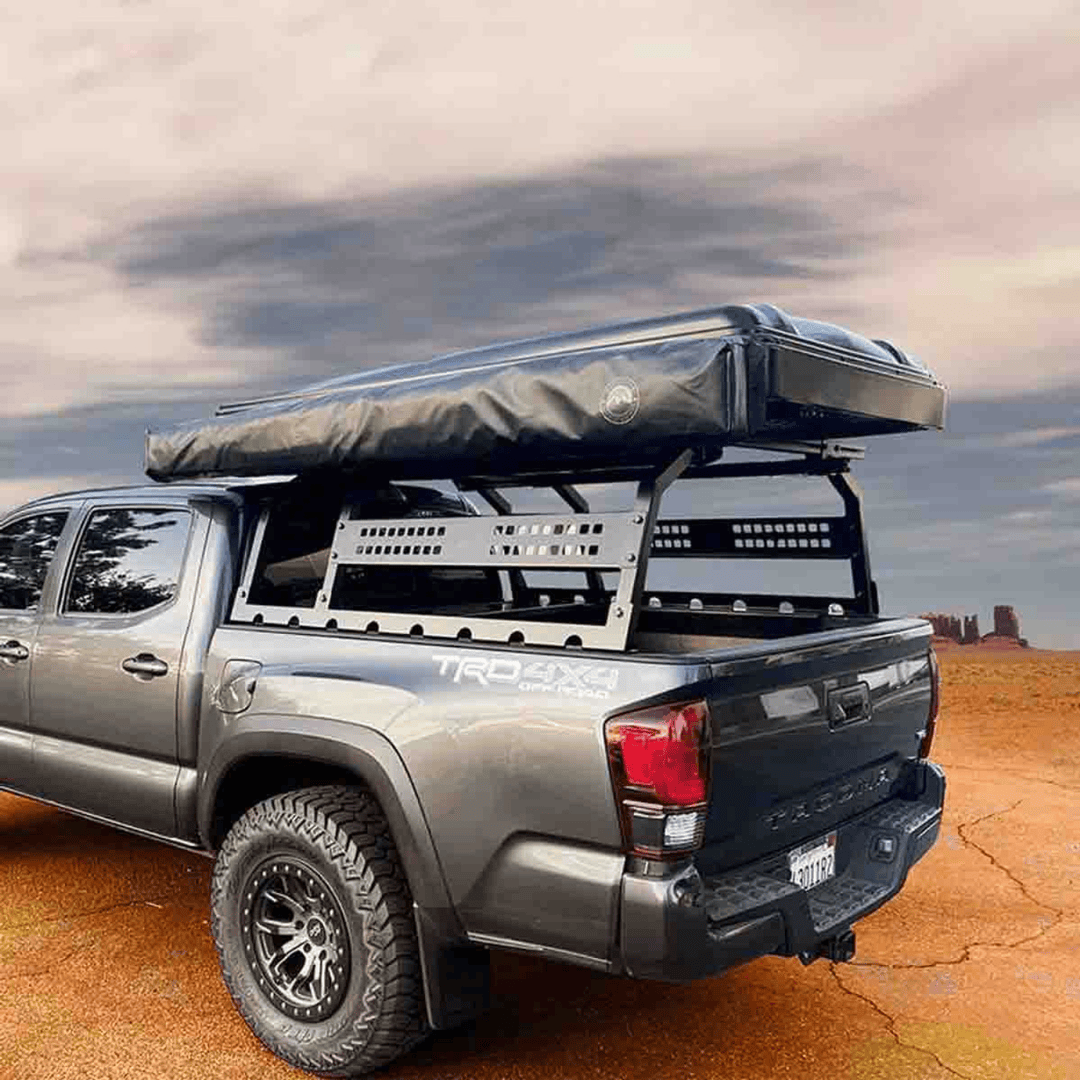 Overland Vehicle Systems Discovery Rack for Mid-Size Truck Short Beds installed with rooftop tent on tacoma