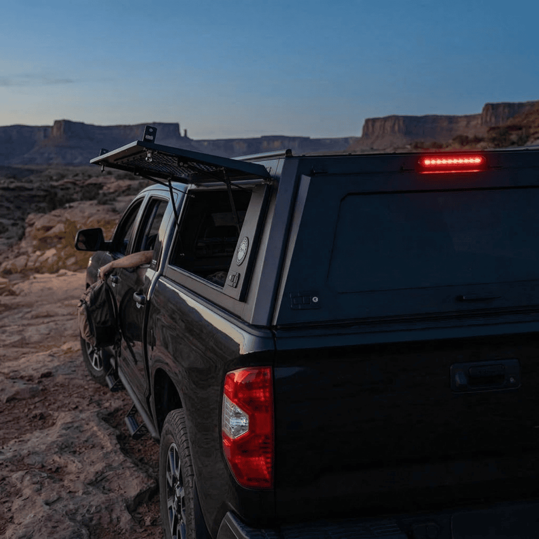 Overland Vehicle Systems Expedition Truck Cap for 2007 to 2021 Toyota Tundra - 5.5 ft. Bed parked with opened windows