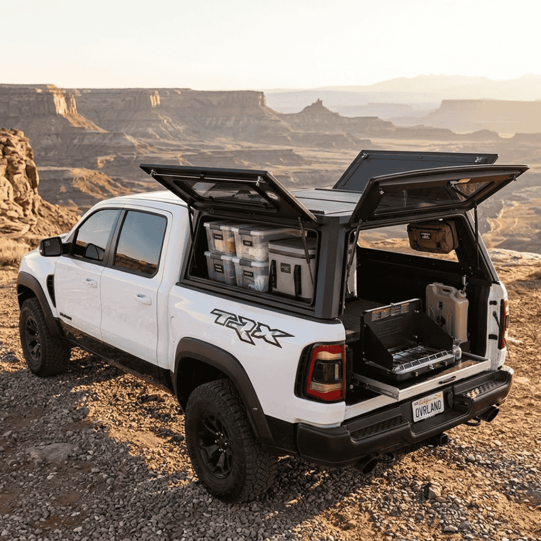 Overland Vehicle Systems Expedition Truck Cap for 2019 to 2026 Ram 1500 DT - 5.7 ft. Bed parked with panels opened