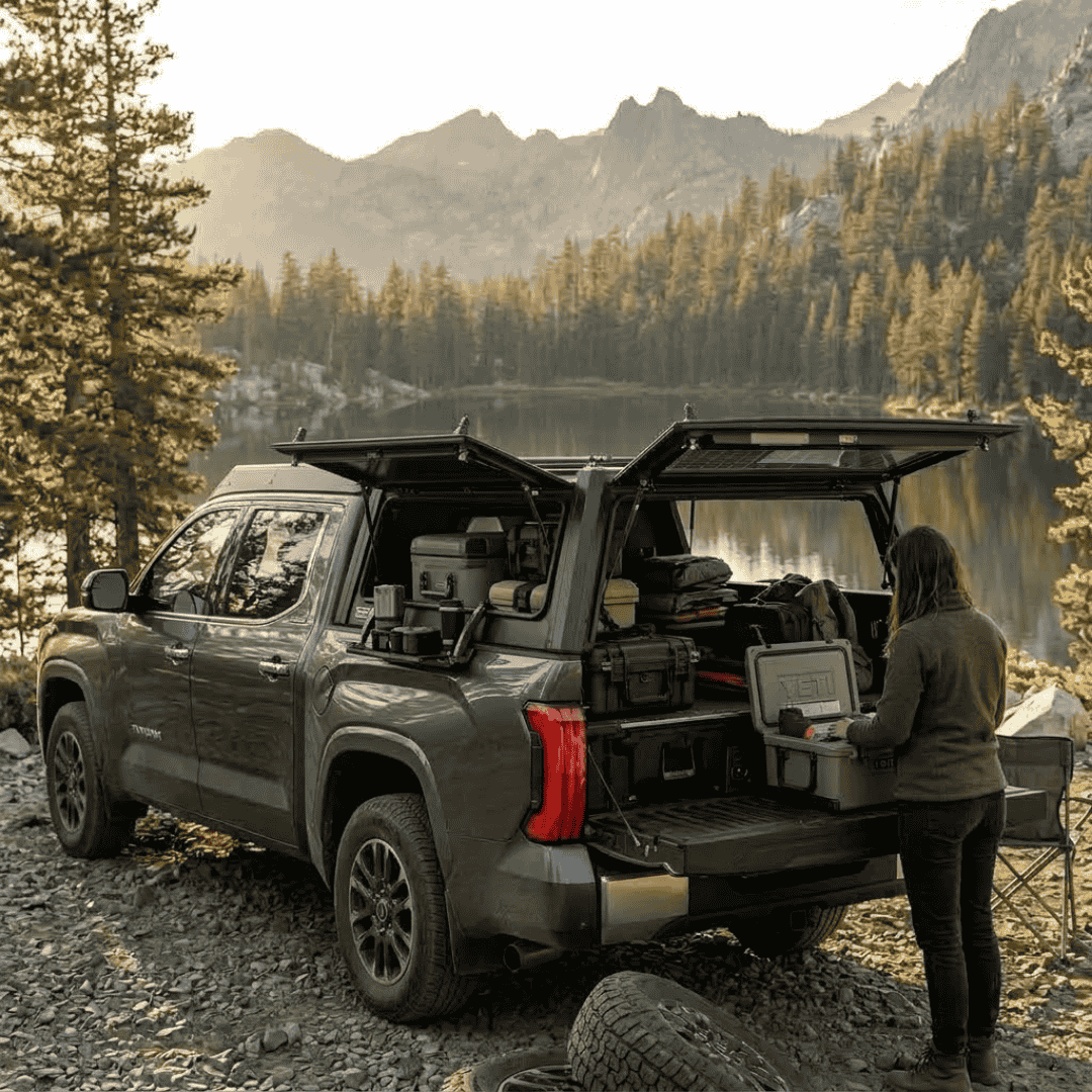 Overland Vehicle Systems Expedition Truck Cap for 2022 to 2026 Toyota Tundra - 5.5 ft. Bed parked with opened windows