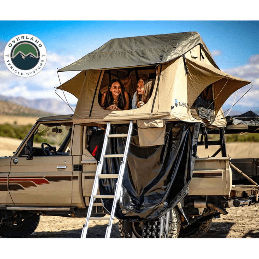 Overland Vehicle Systems LD TMBK Soft Shell Roof Top Tent installed with two girls inside