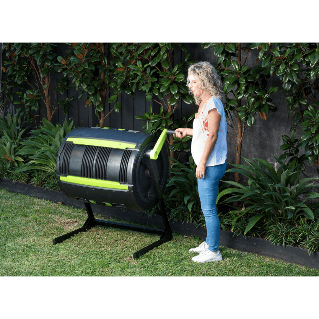 Riverstone Maze 65 Gallon Compost Tumbler being cranked by woman