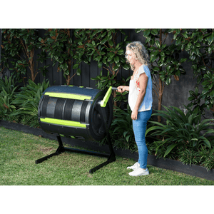 Riverstone Maze 65 Gallon Compost Tumbler being cranked by woman