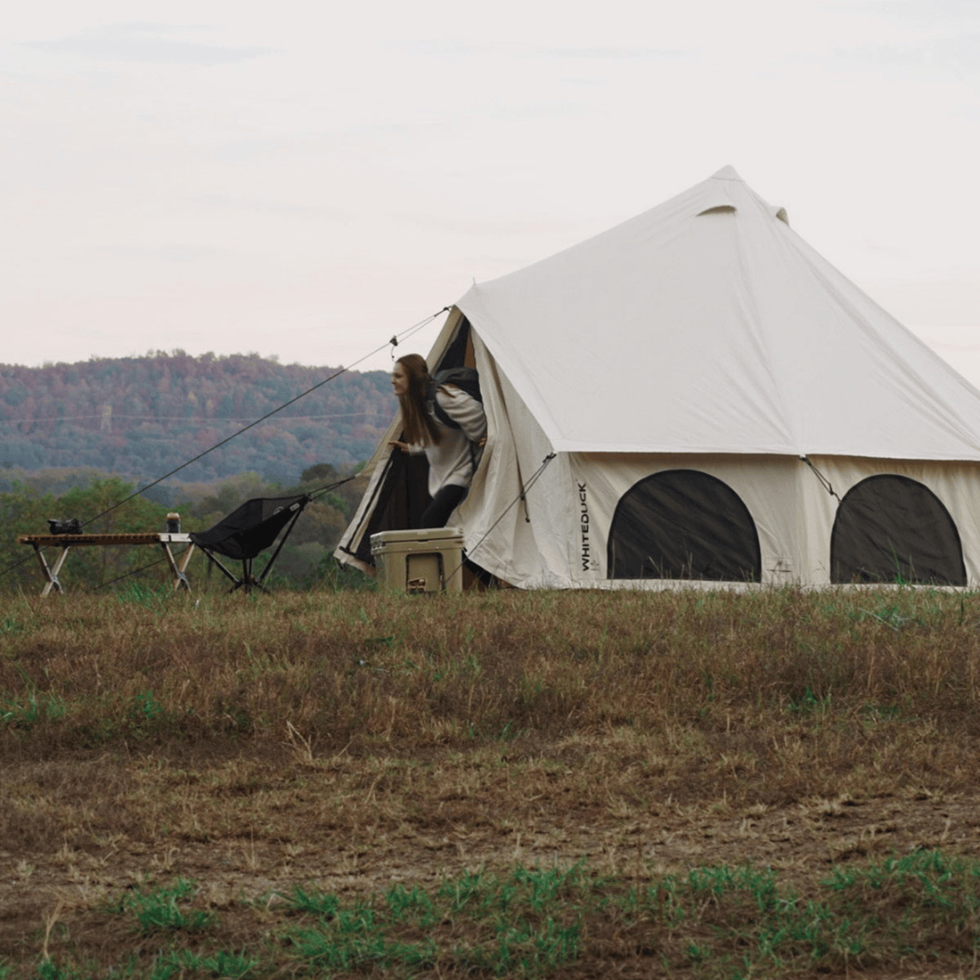 White Duck Outdoors Avalon Bell Tent with woman coming out