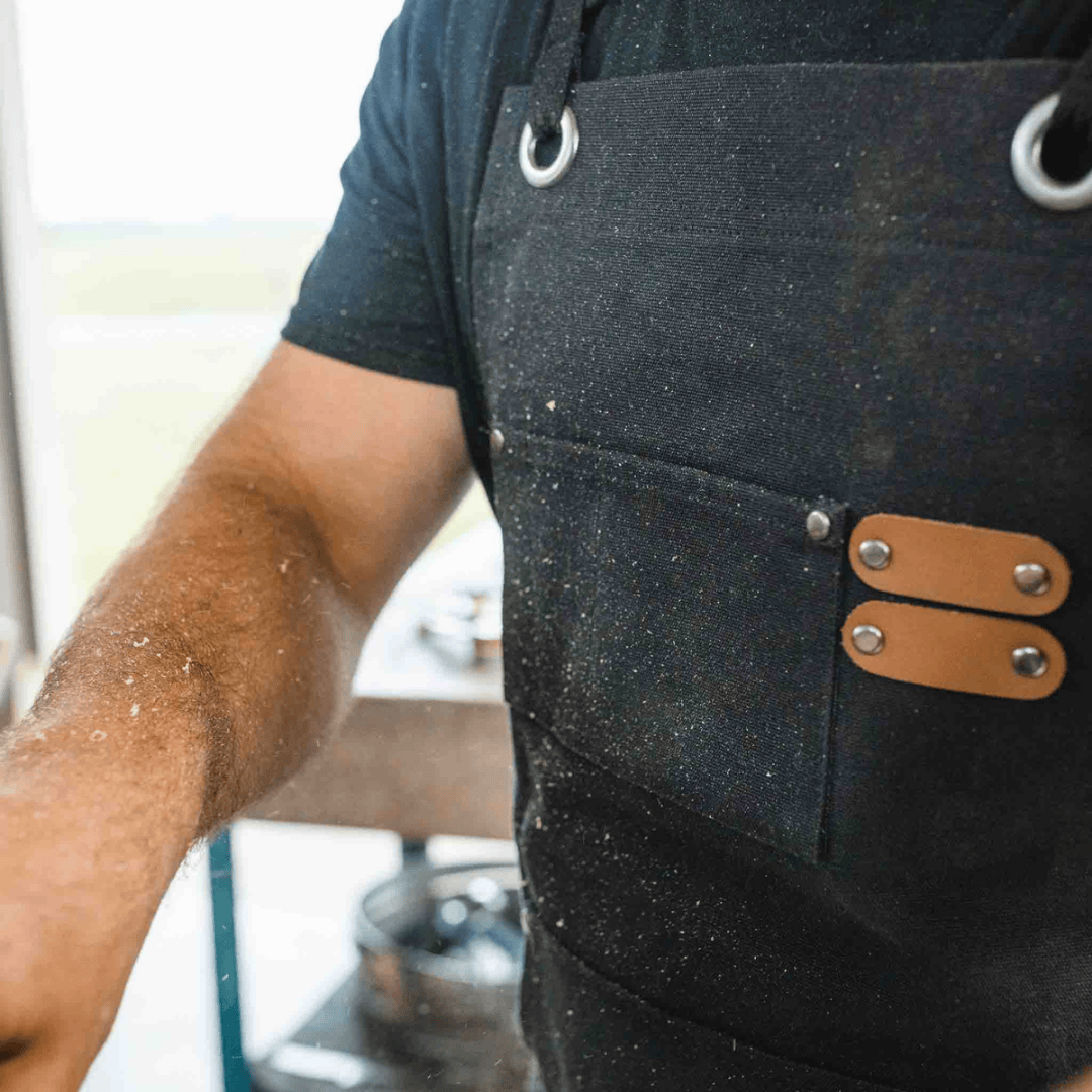 White Duck Outdoors Black Work Apron with sawdust