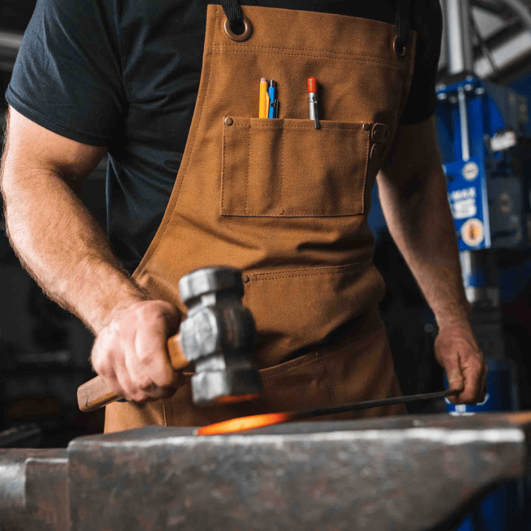 White Duck Outdoors Brown Work Apron with man doing metalwork