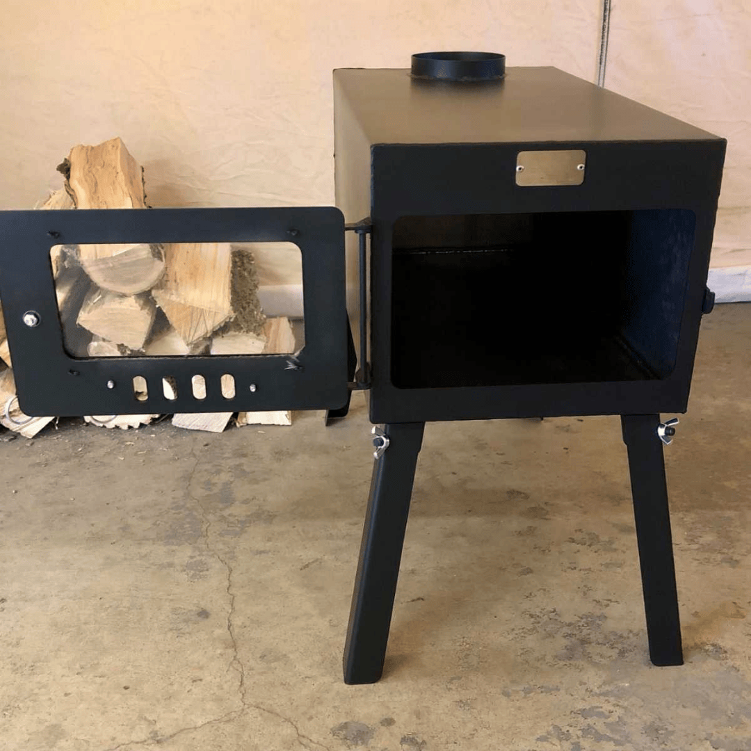 White Duck Outdoors Explorer Wood Stove Kit fully opened with logs in the background