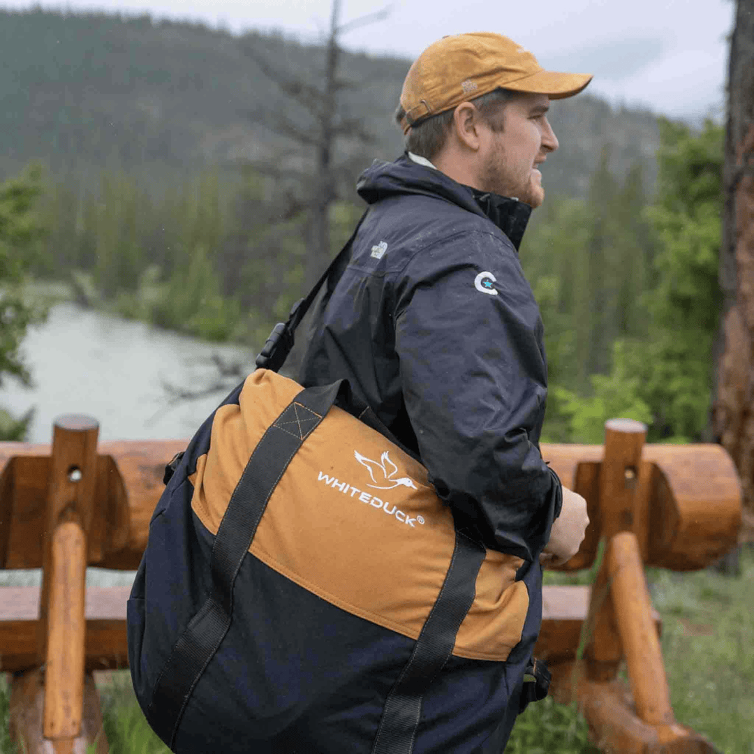 White Duck Outdoors Filios Canvas Duffel Bag 21 x 12 inches over man&#39;s shouler