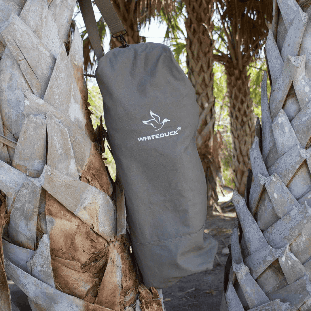 White Duck Outdoors Hoplite Canvas Top Load Bag hung on tree