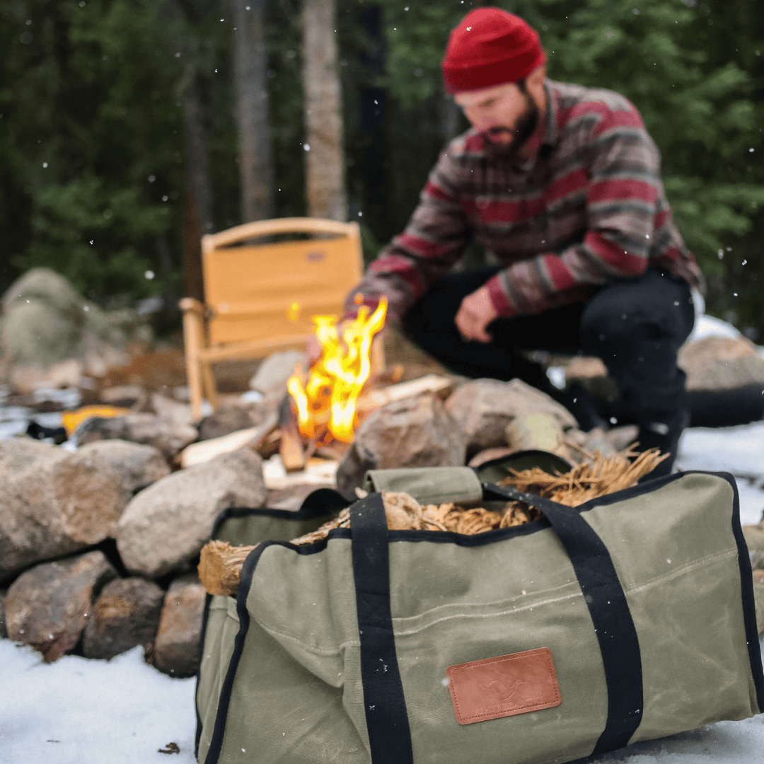 White Duck Outdoors Tote Canvas Log Carrier Bag olive with dry wood by a campfire