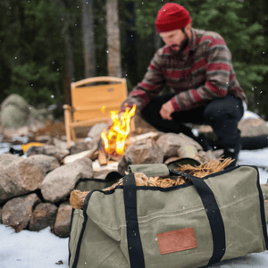 White Duck Outdoors Tote Canvas Log Carrier Bag olive with dry wood by a campfire