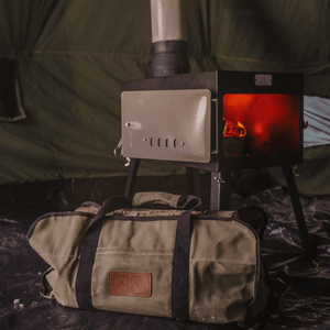 White Duck Outdoors Woodsman Wood Stove Kit beside a log carrier bag