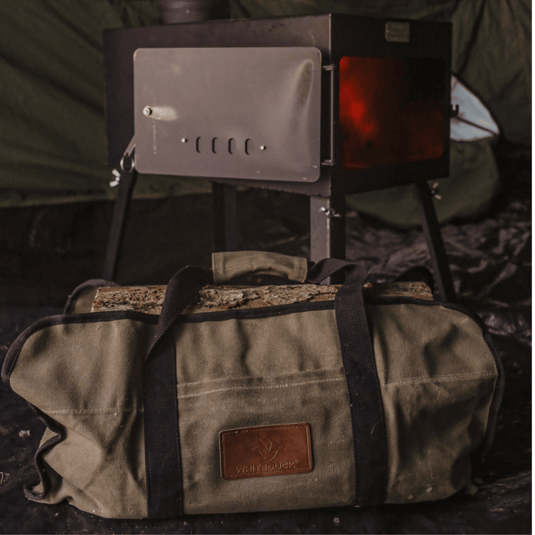 White Duck Outdoors Woodsman XL Wood Stove Kit opened and burning with close up of log carrier bag