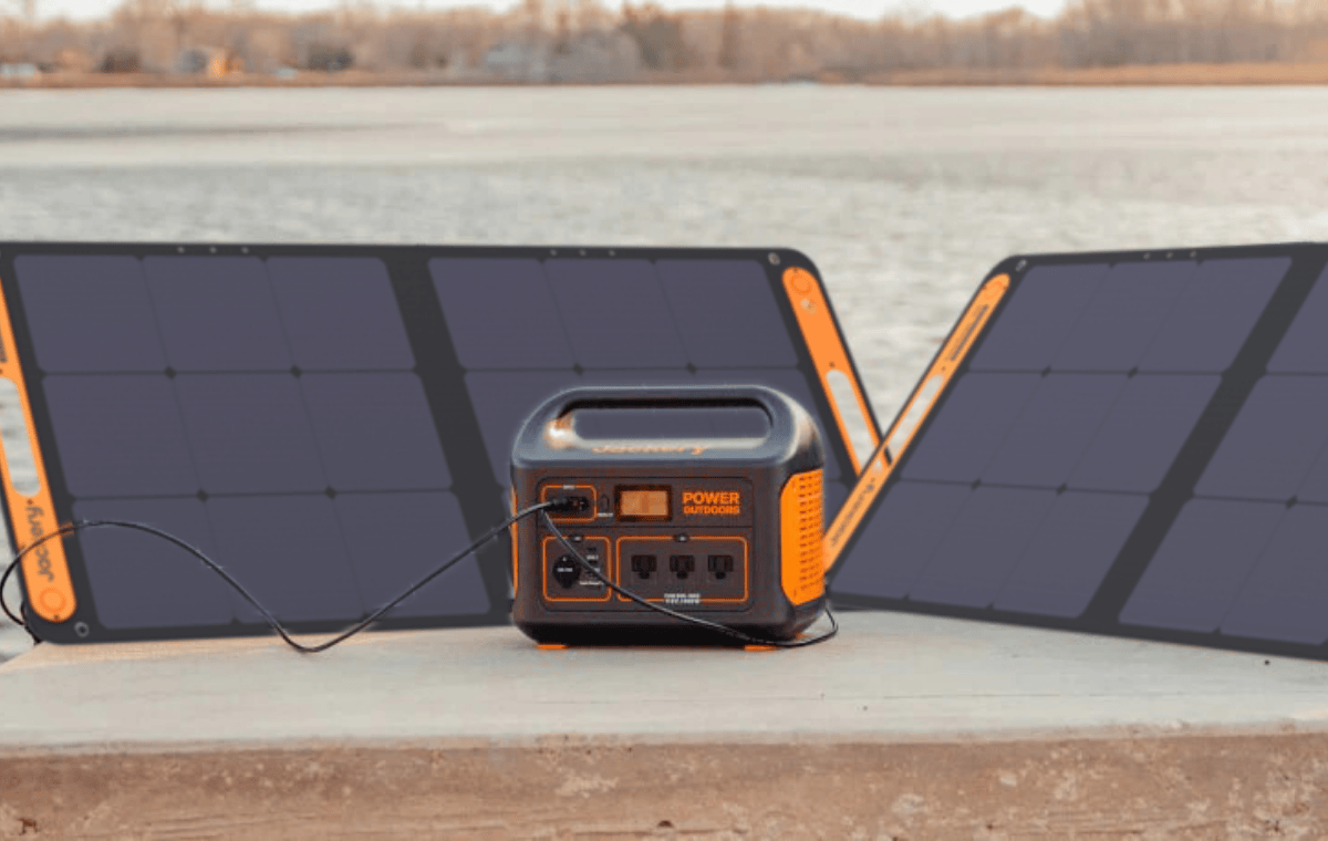 two Jackery SolarSaga 100W Solar Panels charging generator on beach