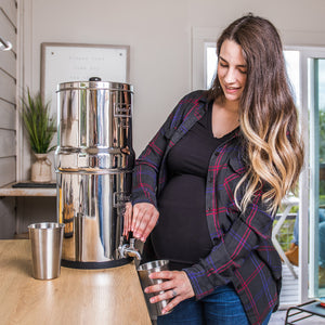 Picture of a Pregnant woman using Berkey® Stainless Steel Tumbler - 16 Oz. (.47 L) on a Berkey Water System - Water Filtration
