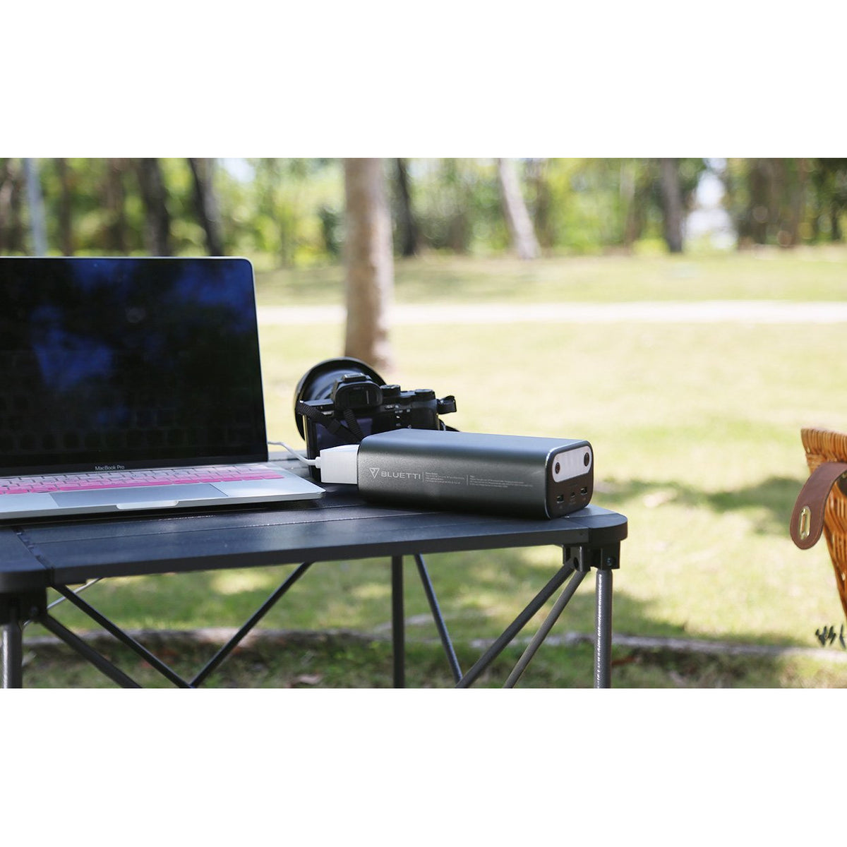 Photo of Bluetti - AC10 99Wh/26756mAh Portable Power Station hooked in a laptop on a table.