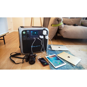 Photo of Bluetti - AC200 1700Wh/2000W Portable Power Station hooked in 3 tablets, 1 cellphone and a camera.