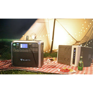 Photo of Bluetti - AC200 1700Wh/2000W Portable Power Station hooked on lights and radio outdoors.