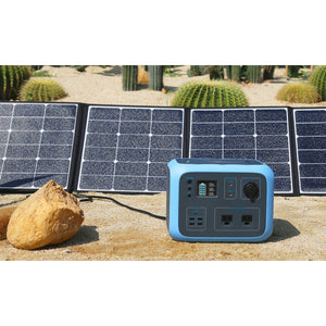 Photo of Bluetti - AC50S 500Wh/300W Portable Power Station charged in solar panels on the ground.