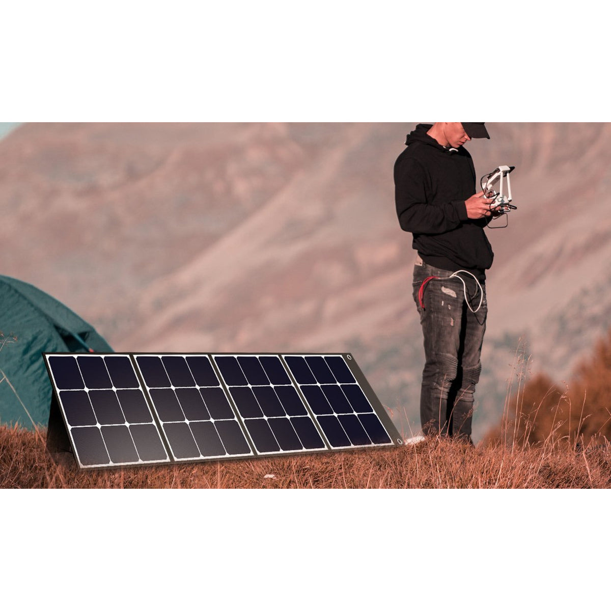 Photo of Bluetti - SP120 120W Solar Panel in a white background with a man beside it.