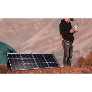 Photo of Bluetti - SP120 120W Solar Panel in a white background with a man beside it.