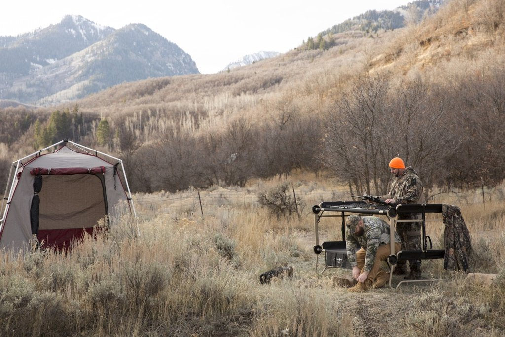 Picture of Disc-O-Bed Cam-O-Bunk Large with Mossy Oak including Organizers being set up by two men.