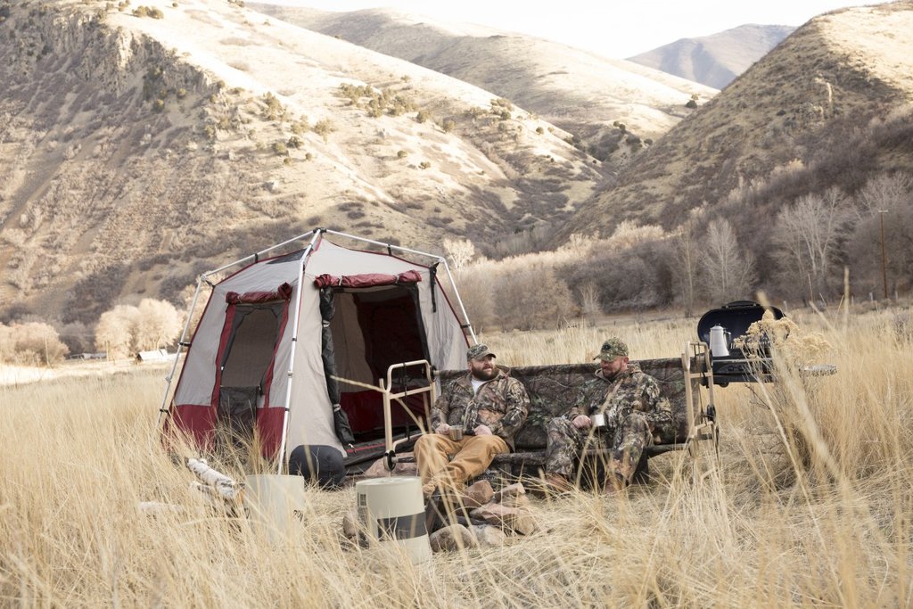 Picture of Disc-O-Bed Cam-O-Bunk Large with Mossy Oak including Organizers being used by two men.