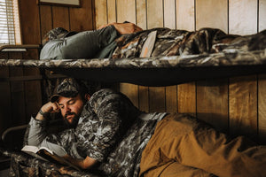 Picture of two men getting rest in a Disc-O-Bed Cam-O-Bunk XL with Mossy Oak including Organizers.