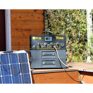 Picture of the Titan Solar Generator with two 2000 watt-hour Battery outdoor placed in a wooden base beside a panel. - Point Zero Energy Generators